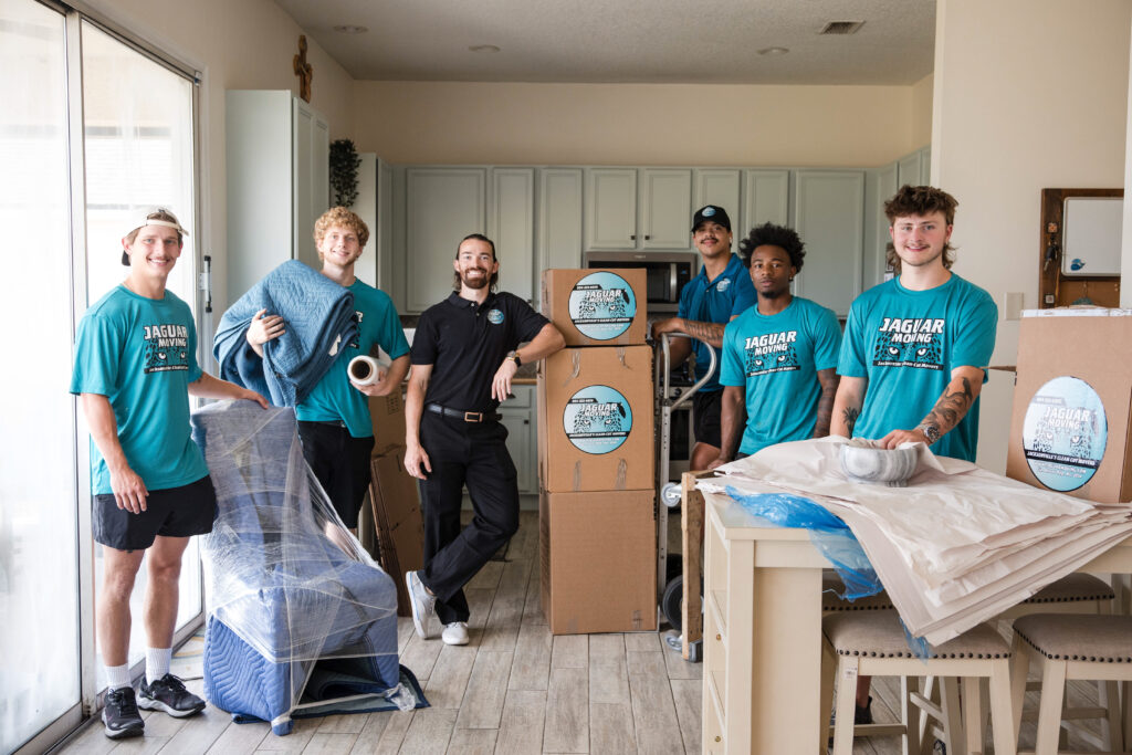 Jaguar Moving team carefully carrying furniture during a residential move in Jacksonville, FL