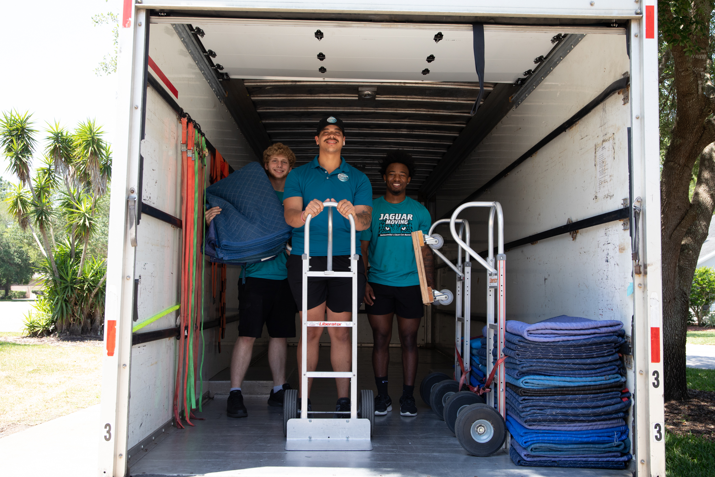 Jaguar Moving team carefully carrying furniture during a residential move in Jacksonville, FL