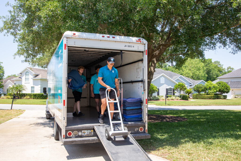 Jaguar Moving team carefully carrying furniture during a residential move in Jacksonville, FL